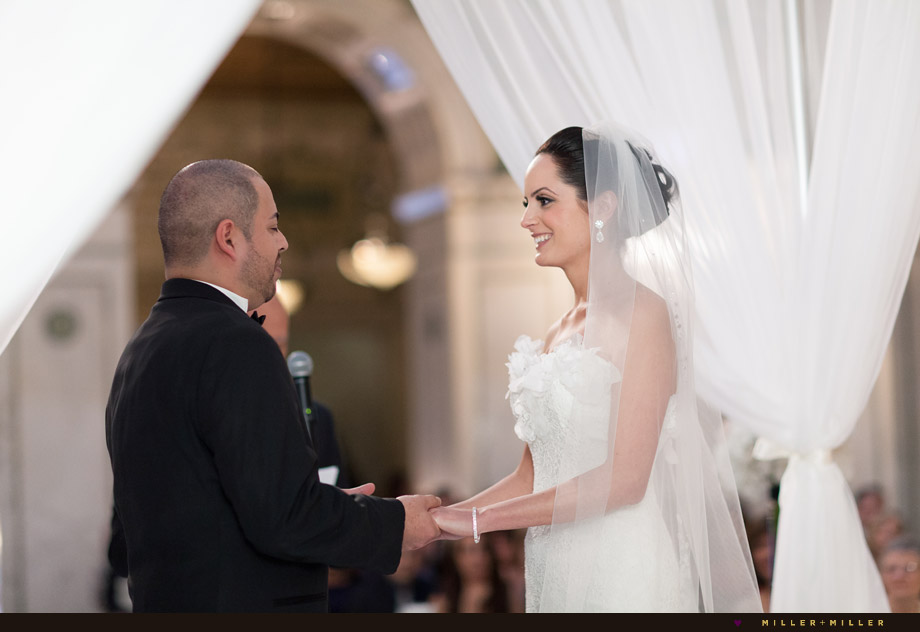 vows under draped white fabric
