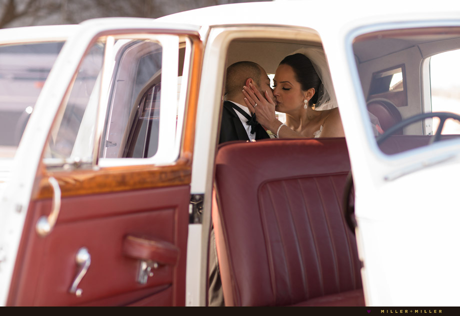 bride groom kissing inside classic car